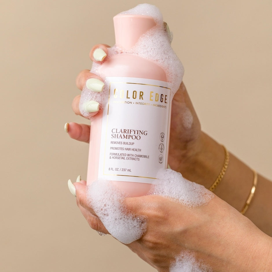 Clarifying Shampoo with bubbly suds around bottle