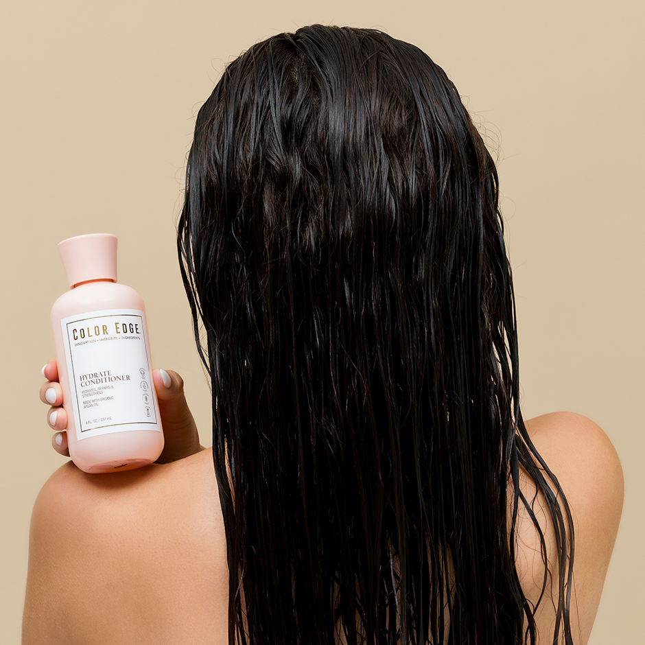 Woman holding Hydrate Conditioner in her hand