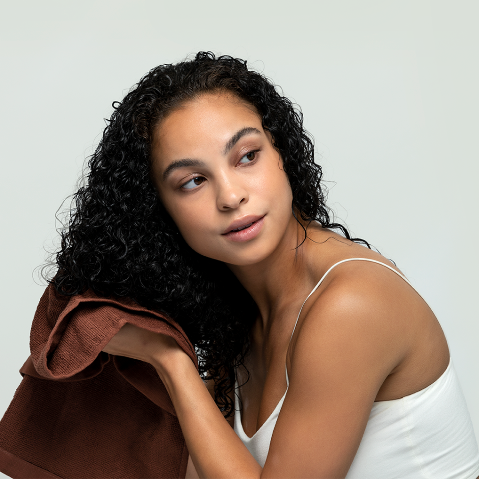 Model drying hair with towel