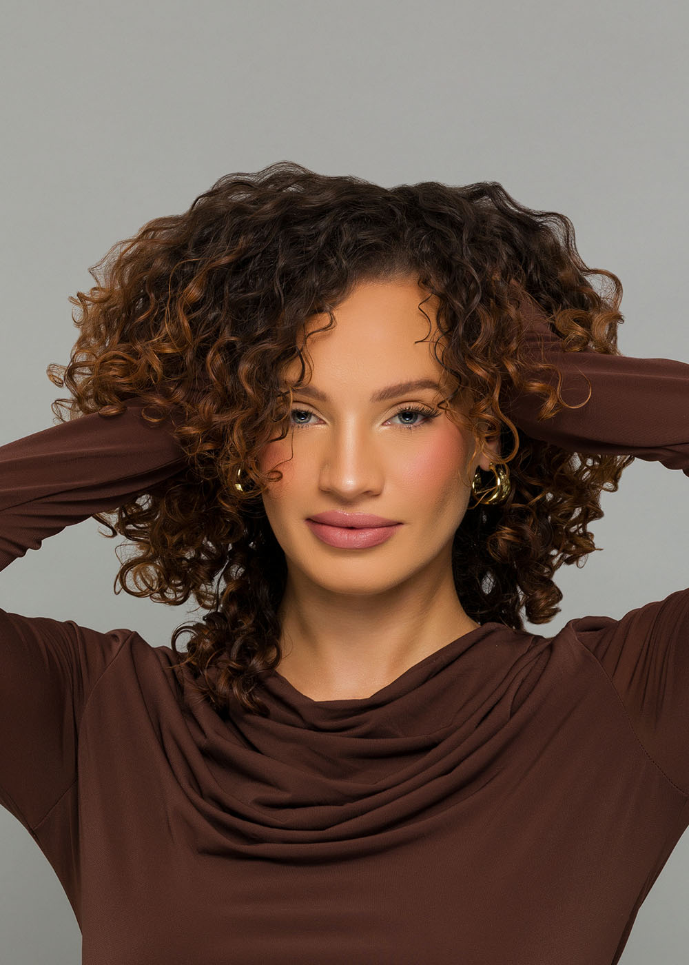 Woman with ashy brown hair, with lighter highlights