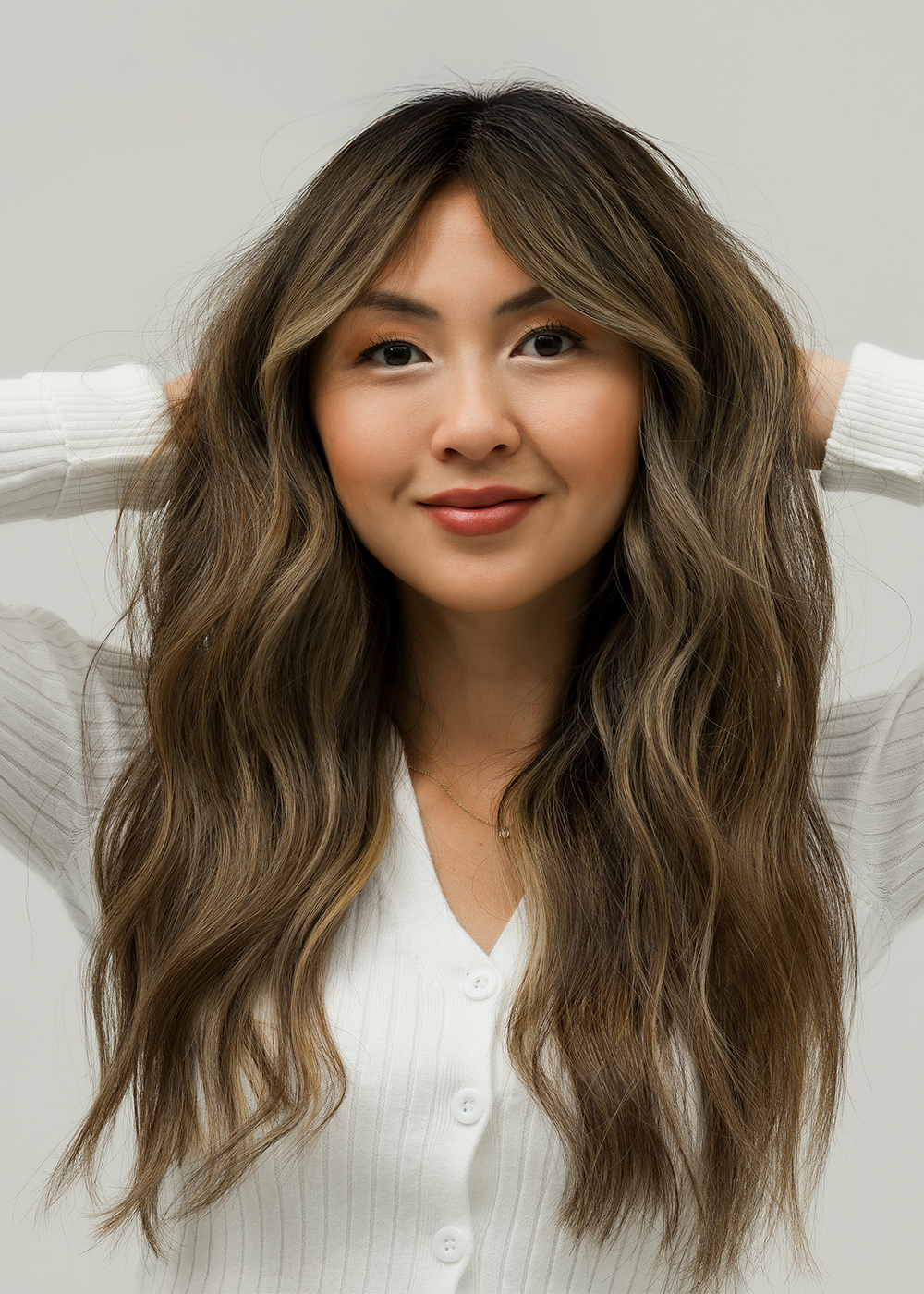 Woman with ashy brown hair, with lighter highlights