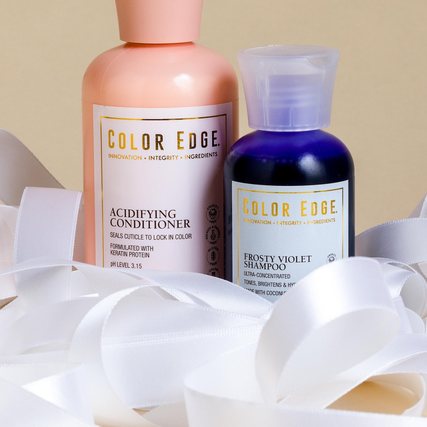 Color Edge shampoo and conditioner bottles with white ribbons