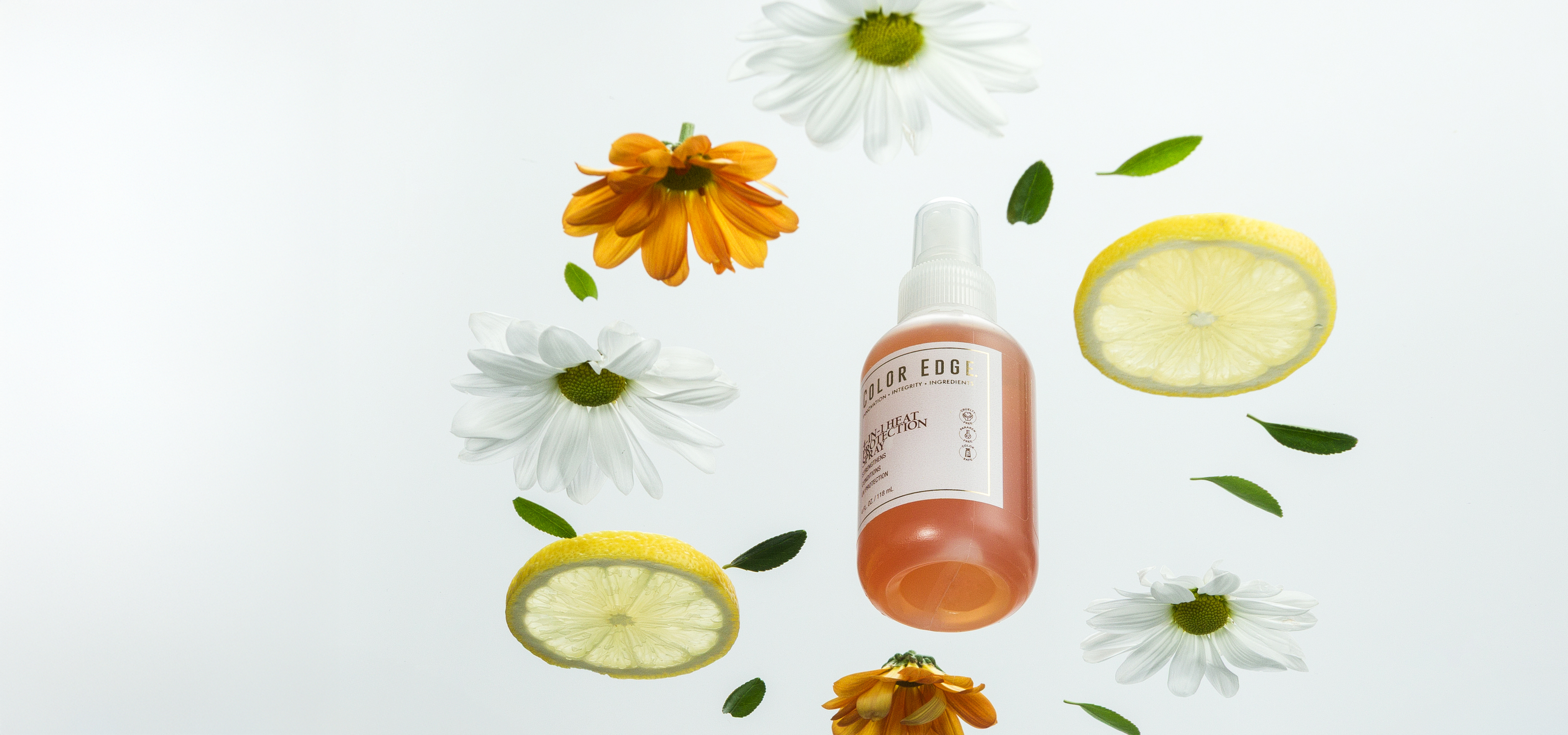 4-in-1 Heat Protection Spray surrounded by flowers