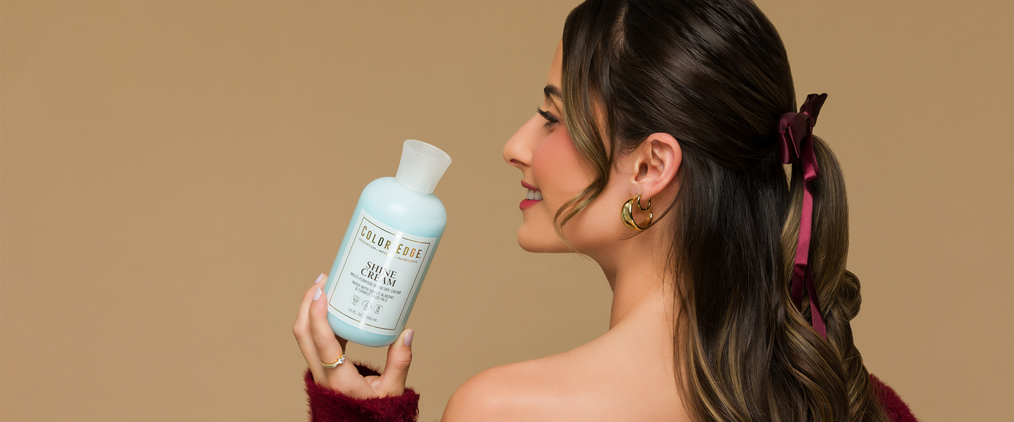 Woman holding Shine Cream bottle