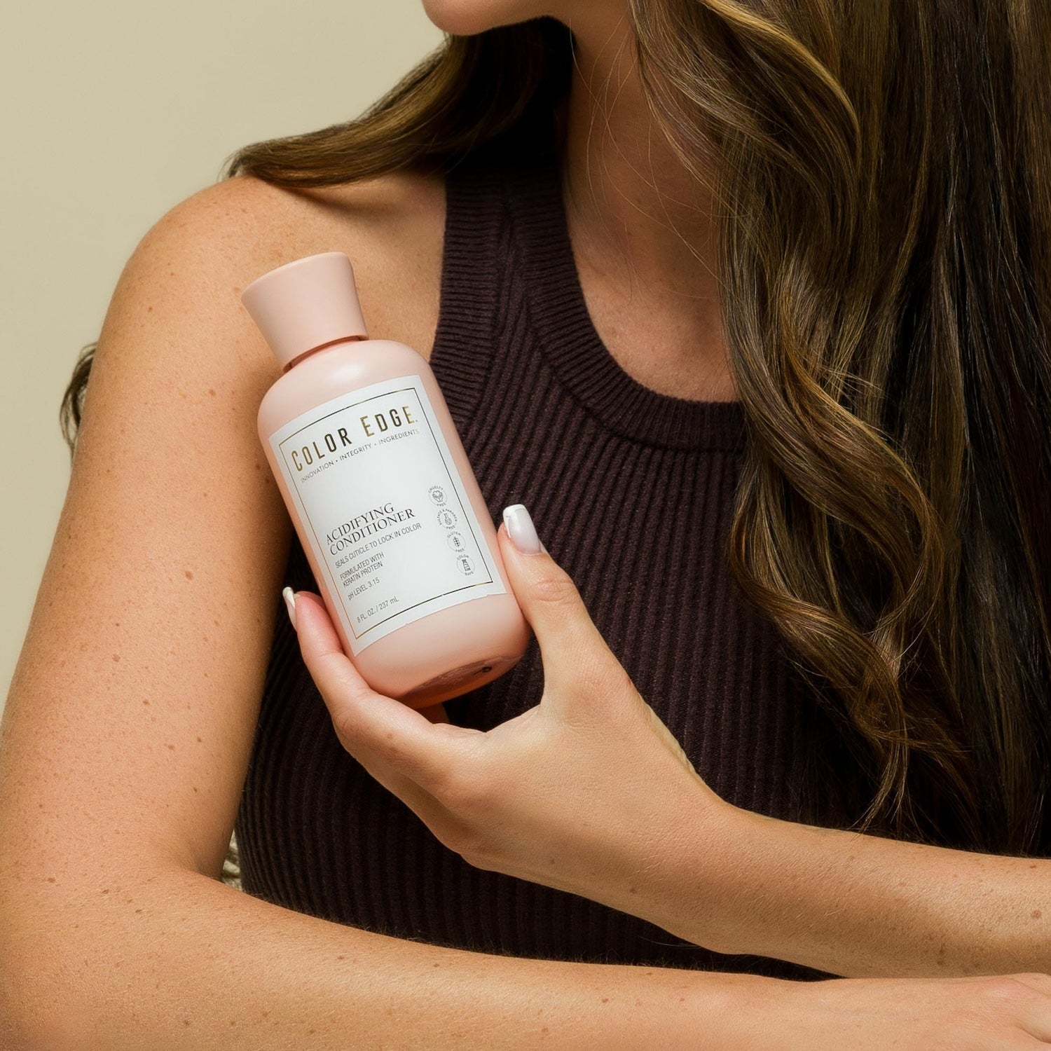 Woman holding a bottle of Acidifying Conditioner