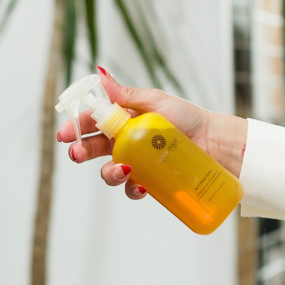 Woman holding Anti-fade Spray in hand
