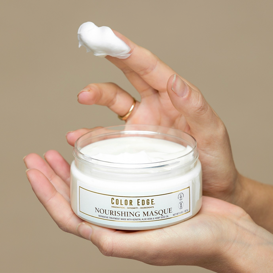 Woman getting a swatch of Nourishing Masque on her fingertips