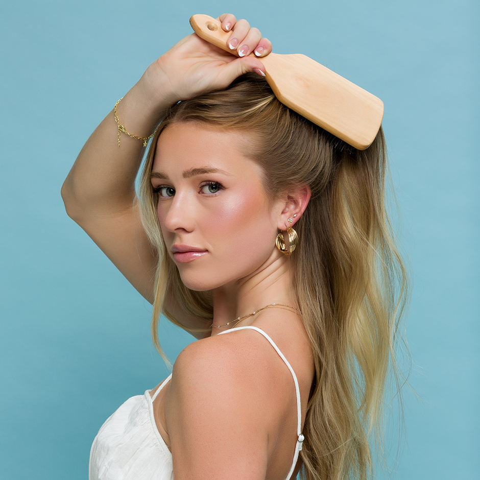 Woman brushing her hair with Paddle Brush