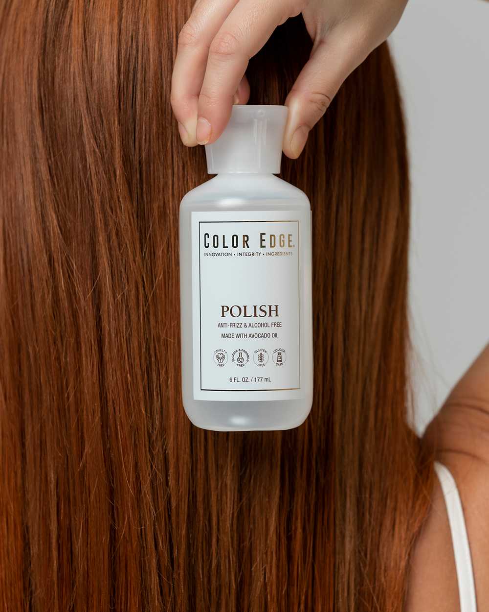 Bottle of Color Edge Polish held against red hair