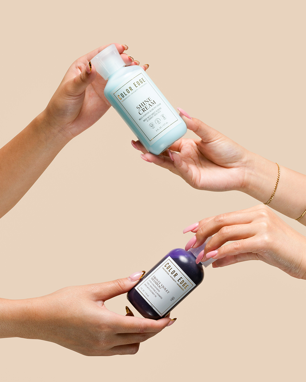Two hands swapping bottles of Color Edge products
