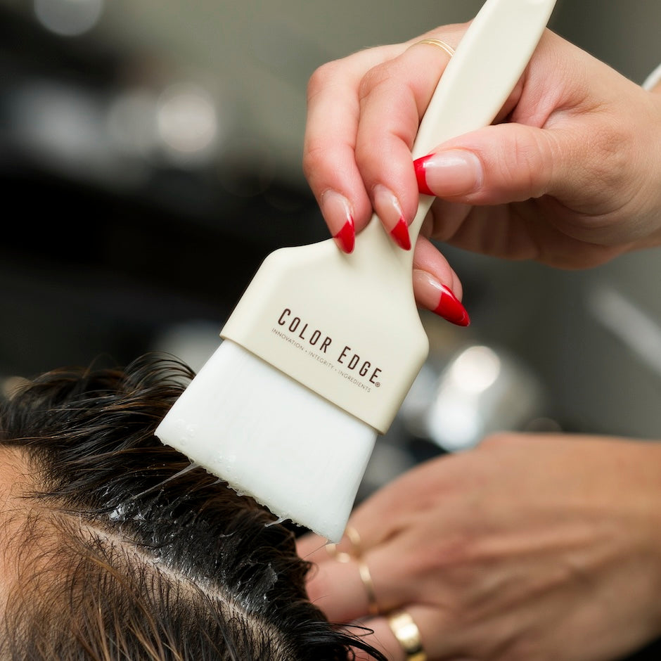 Stylist applying product to client's hair using Bamboo Root Tint Brush