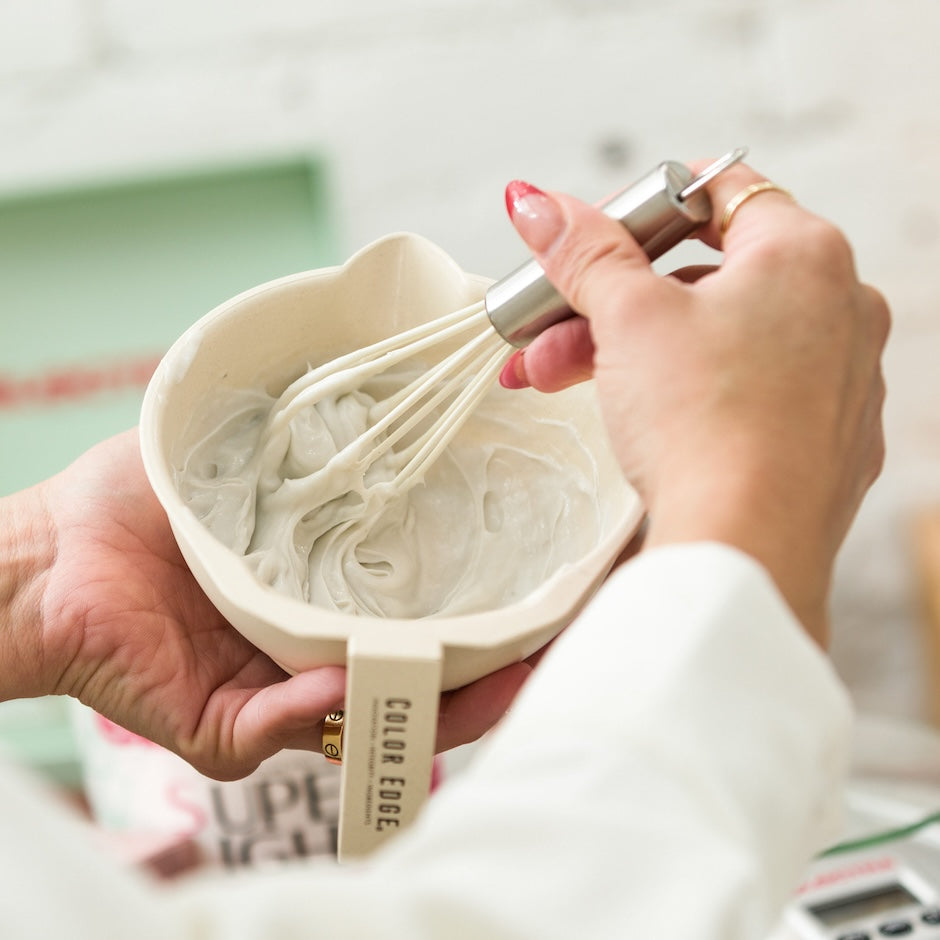 Stylist mixing color with Bamboo Tint Bowl and Color Whisk