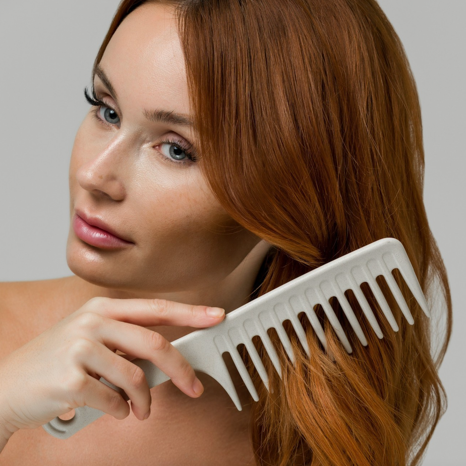 Woman combing her hair with Wide Tooth Comb