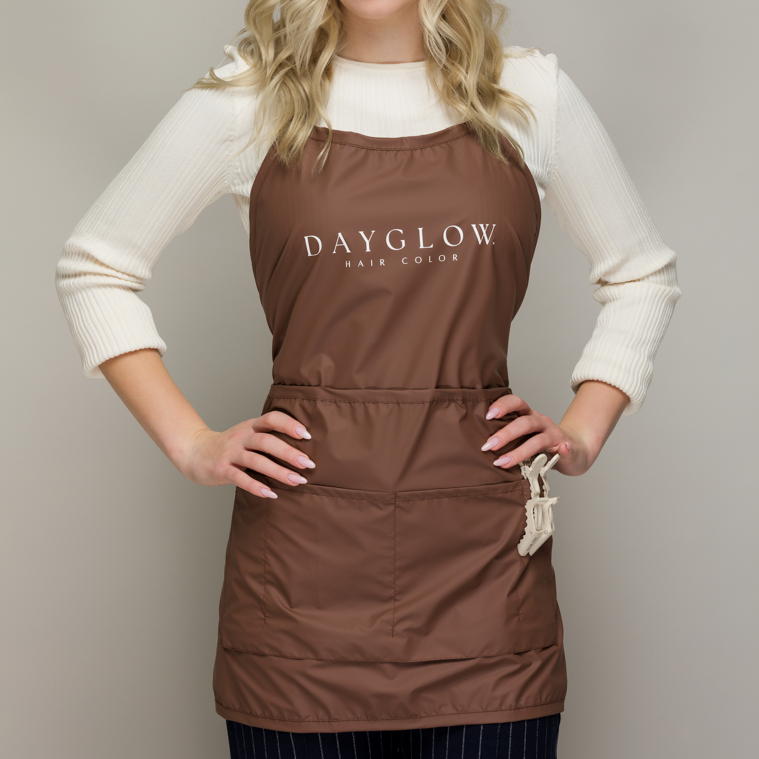 Woman wearing a brown color apron with Dayglow Logo