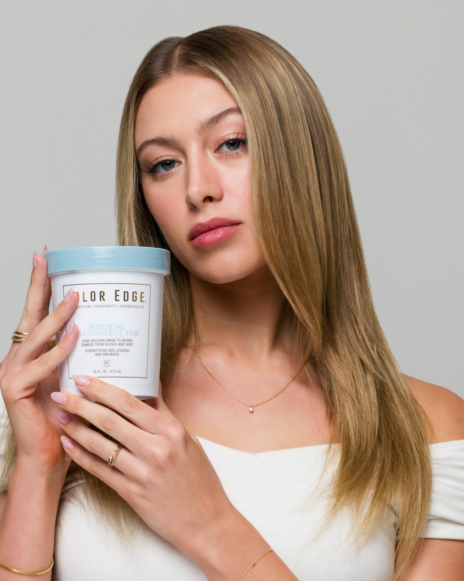Woman holding Bonding Reconstructor next to face