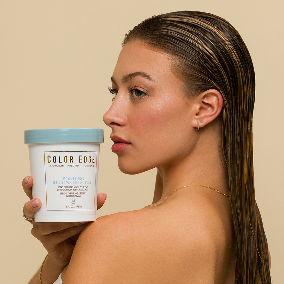 Woman holding a container of Bonding Reconstructor