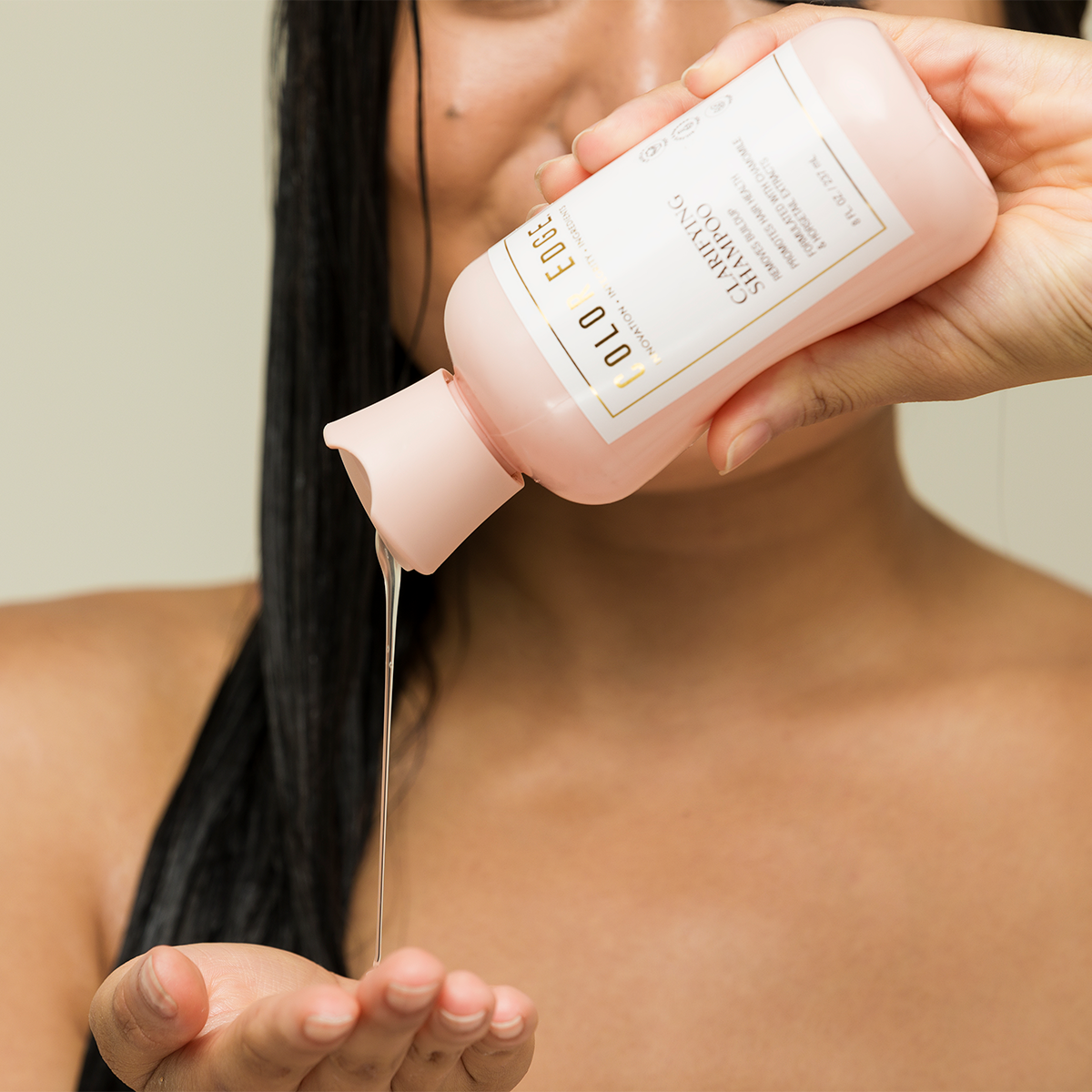 Model squeezing Clarifying Shampoo in hand